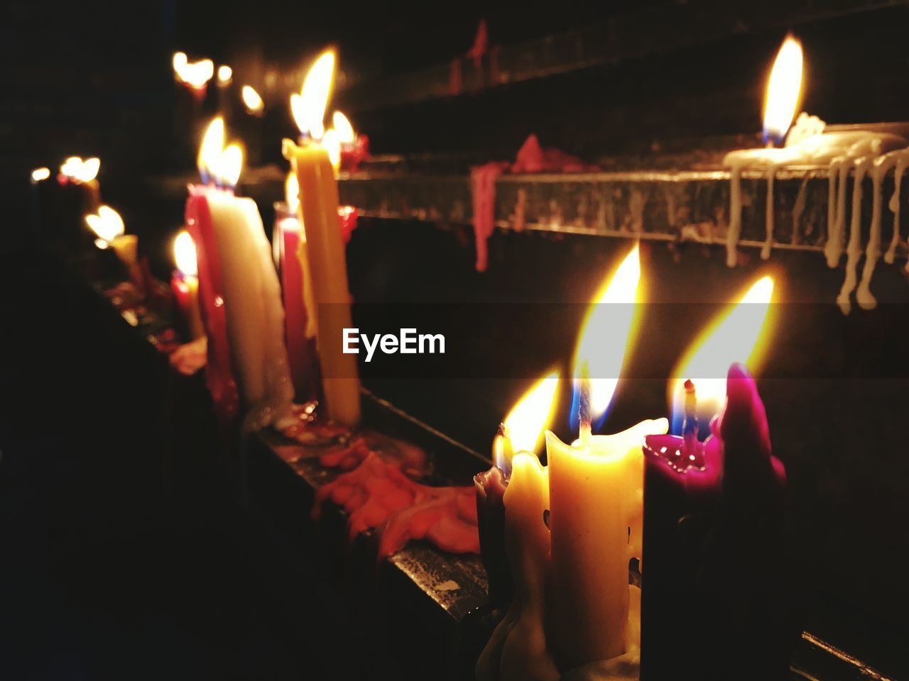 CLOSE-UP OF LIT CANDLES IN FIRE