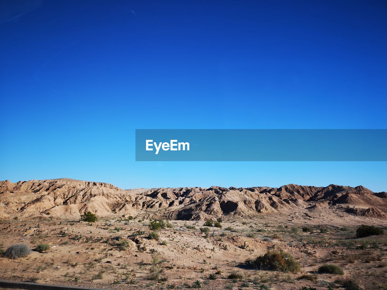 Rock formations in desert against clear blue sky