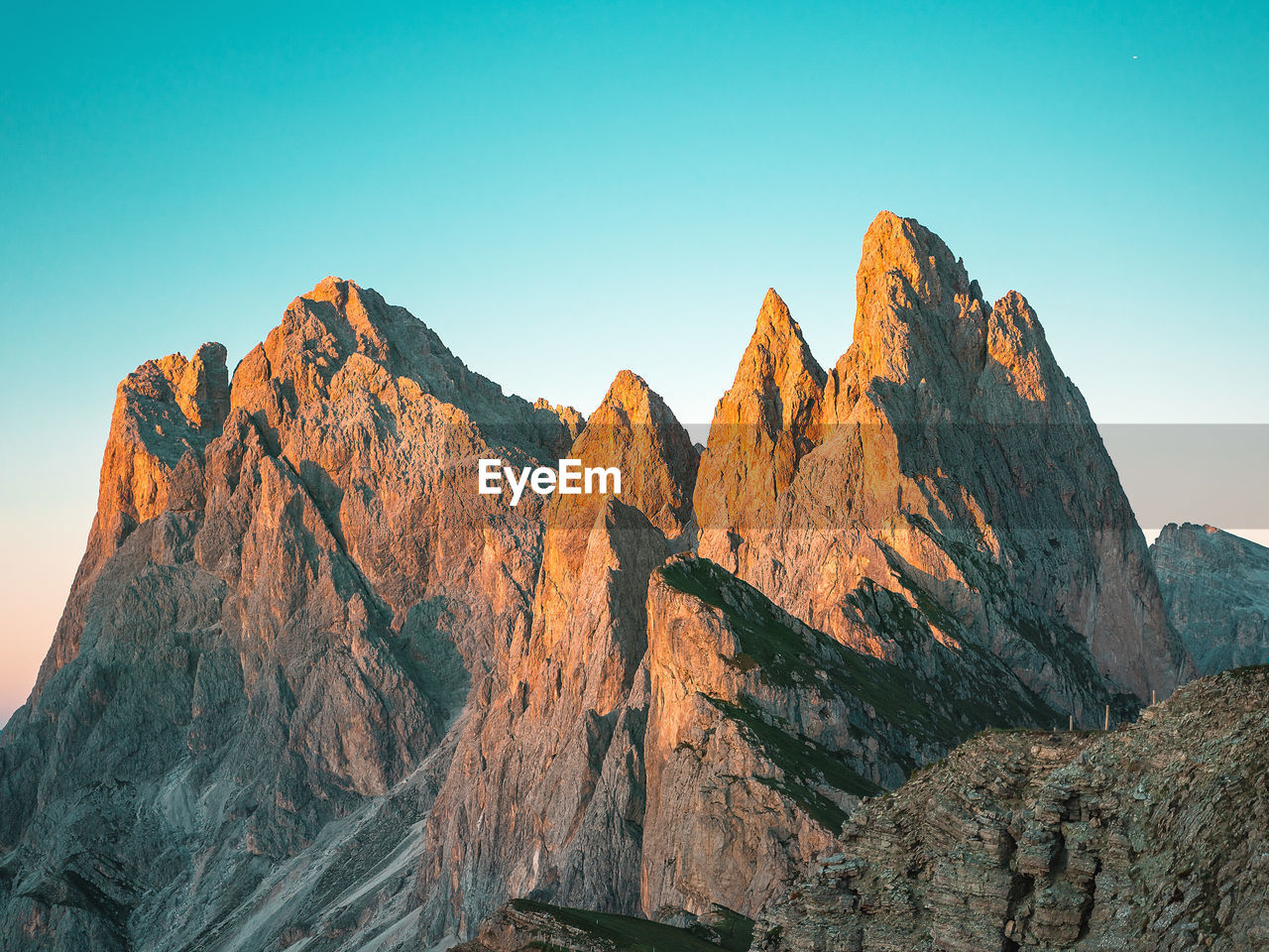 Panoramic view of rocky mountains against clear blue sky