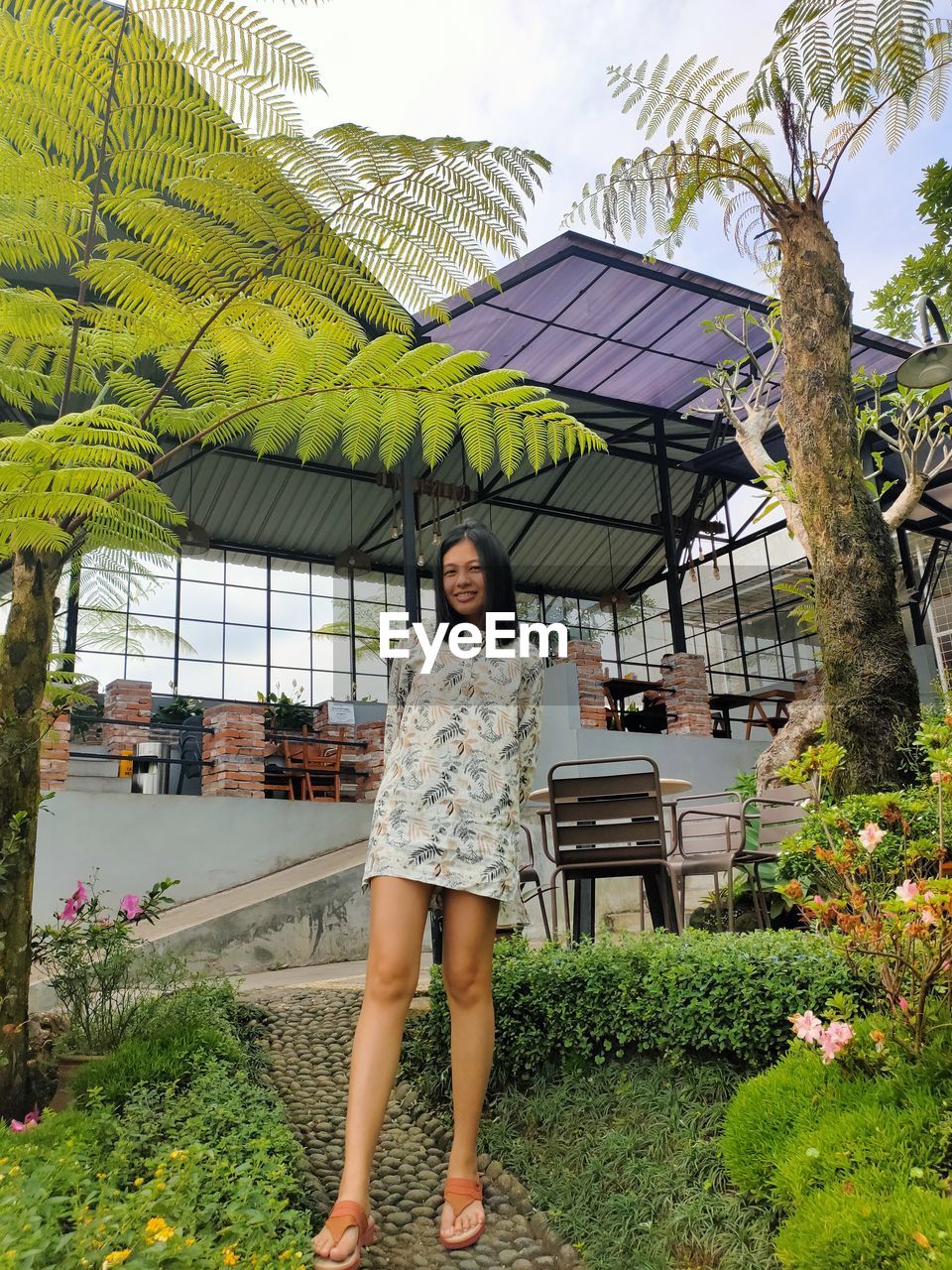 Girl standing by the garden