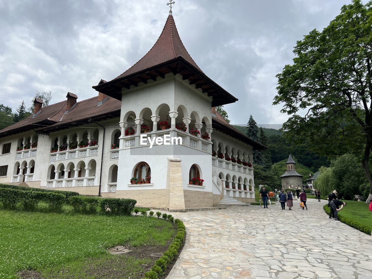 architecture, built structure, building exterior, building, travel destinations, sky, plant, history, nature, the past, religion, estate, travel, cloud, tourism, château, tree, palace, belief, historic site, place of worship, city, mansion, grass, outdoors, temple - building, group of people, tourist, spirituality, beauty in nature, temple, landmark, environment, facade