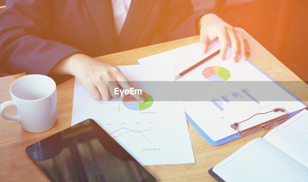 Midsection of businesswoman working at office