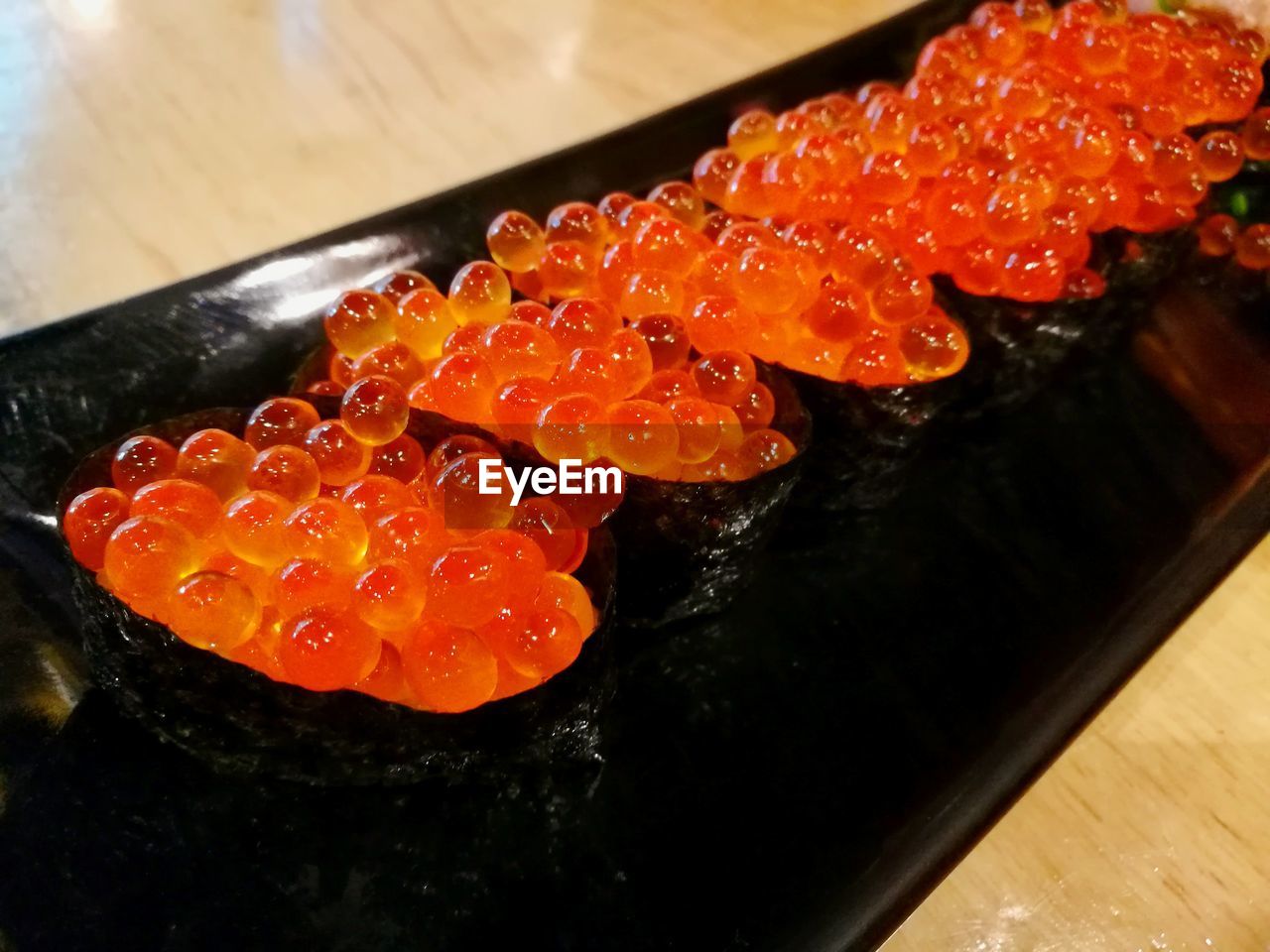 CLOSE-UP OF SUSHI ON ORANGE