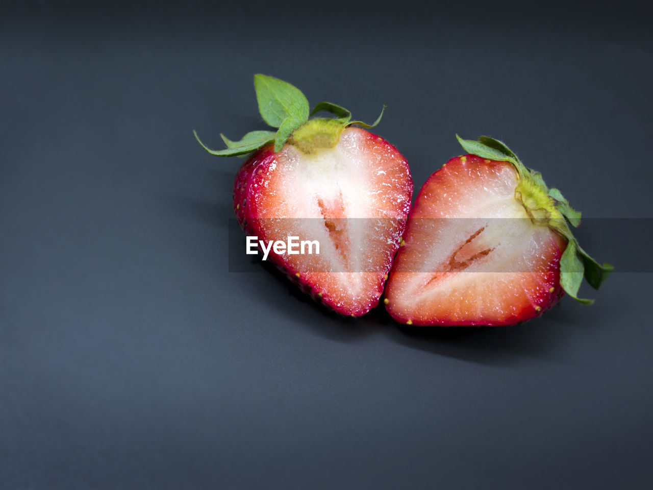 High angle view of strawberries on black background