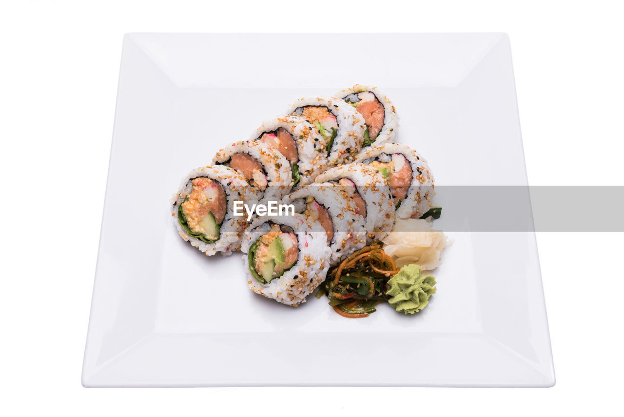 High angle view of fresh sushi in plate against white background
