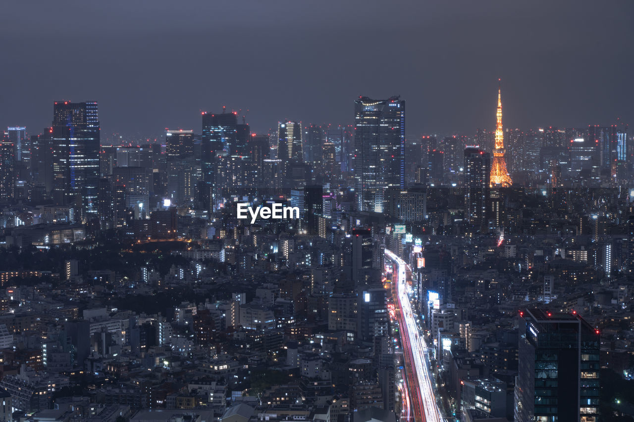 ILLUMINATED BUILDINGS IN CITY AT NIGHT