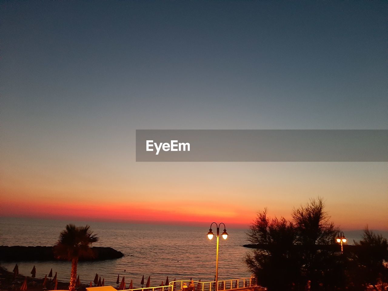 SCENIC VIEW OF SEA AGAINST ORANGE SKY