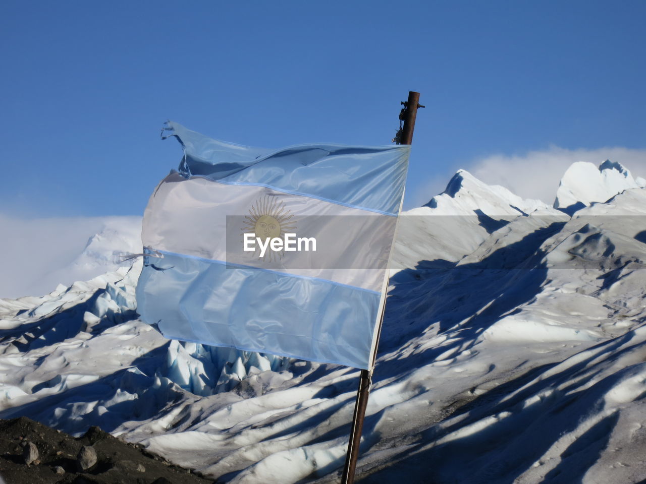 Argentinian flag against snow covered mountains