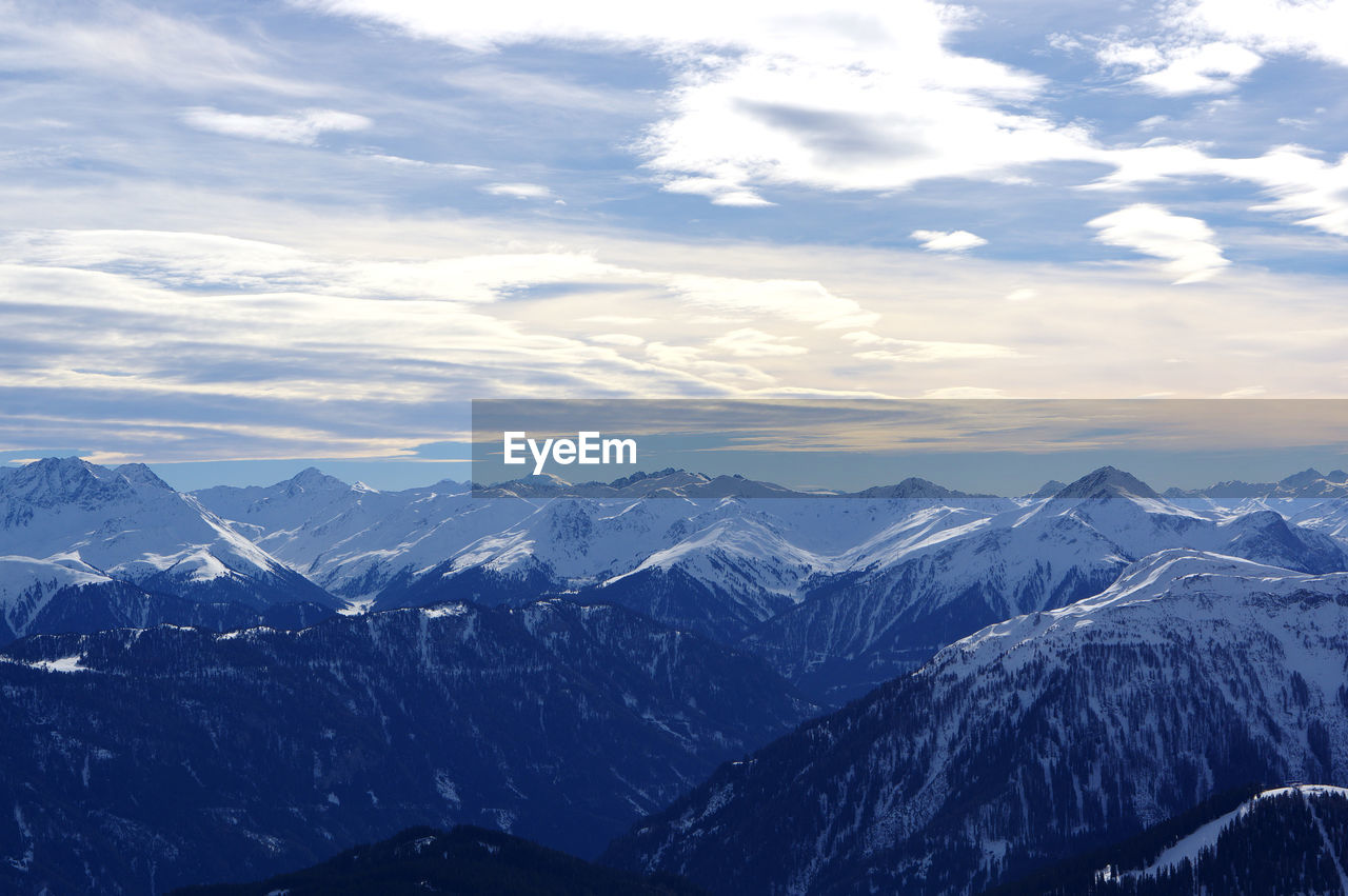 Scenic view of mountains against cloudy sky