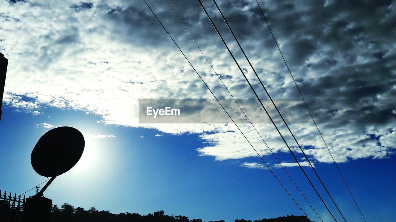 LOW ANGLE VIEW OF SILHOUETTE POWER CABLES AGAINST SKY