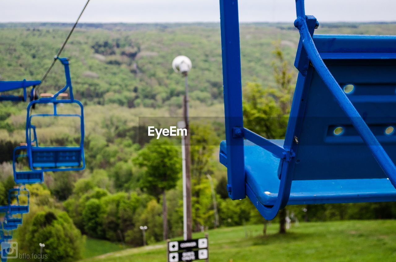 Close-up of blue chairlifts