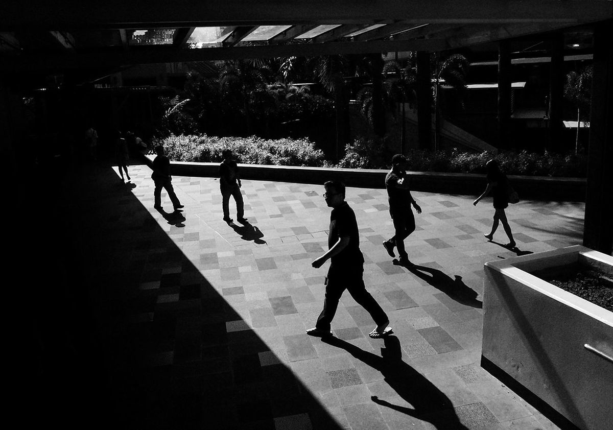 PEOPLE WALKING ON FLOOR IN CORRIDOR