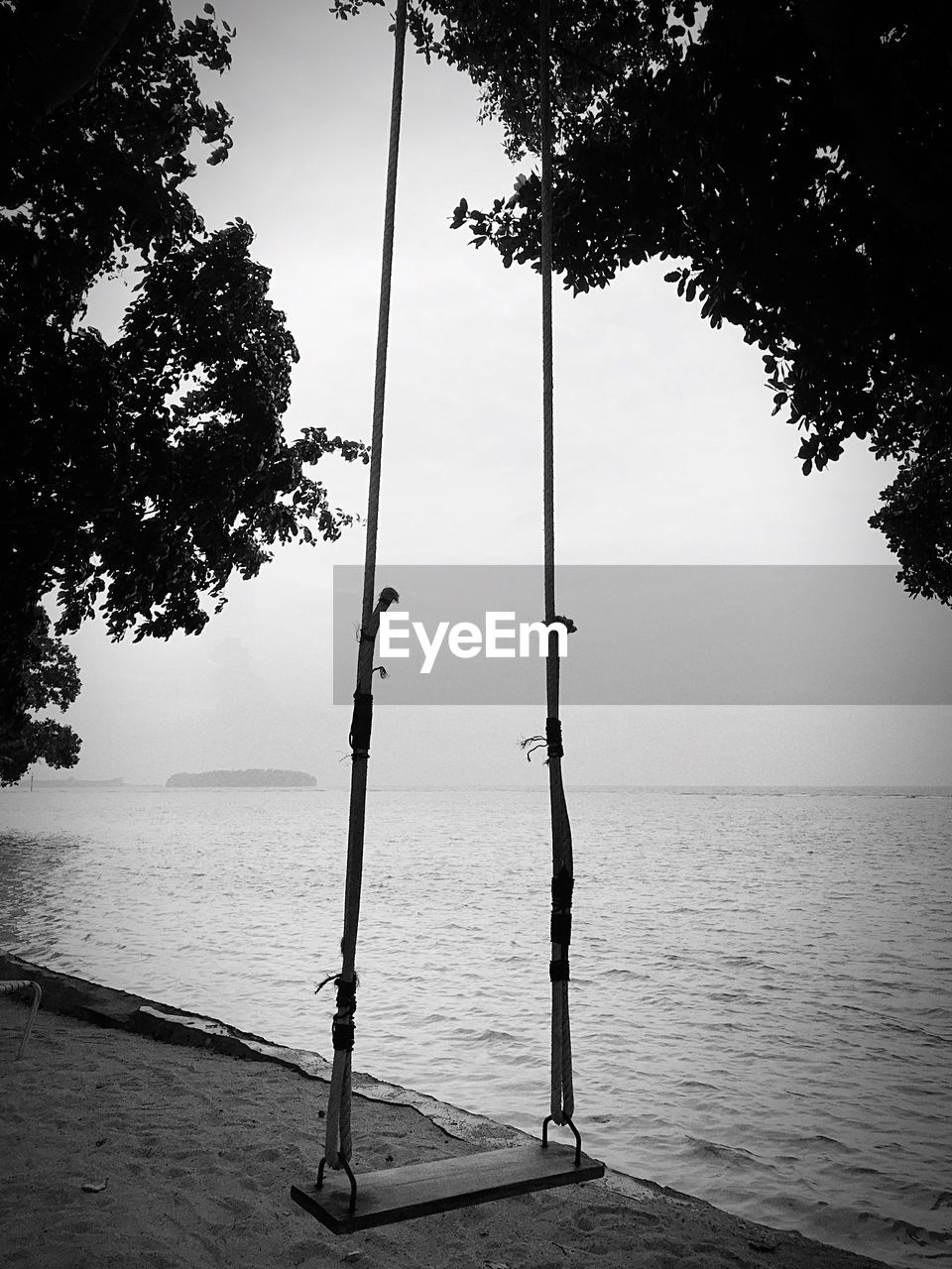 VIEW OF EMPTY SWING AGAINST SKY
