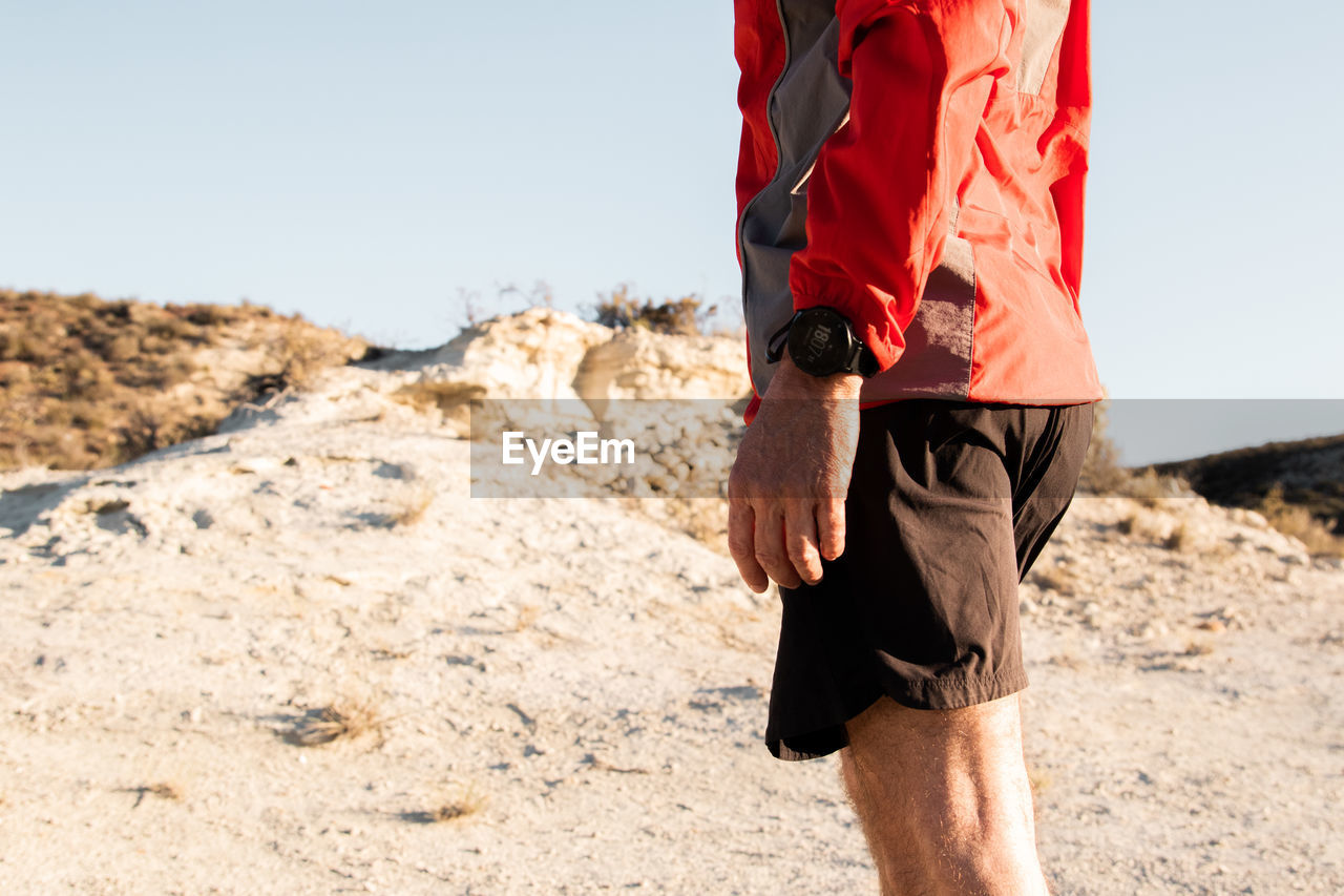 Sport watch detail of anonymous mature sportsman getting ready to run