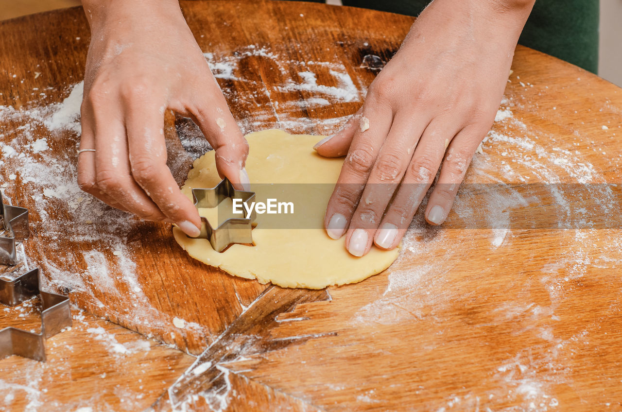 Cook kneads the cookie dough with his hands