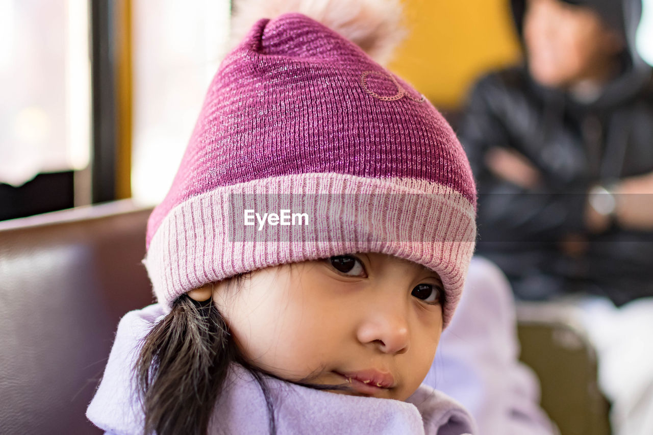 CLOSE-UP PORTRAIT OF CUTE BABY GIRL IN SNOW