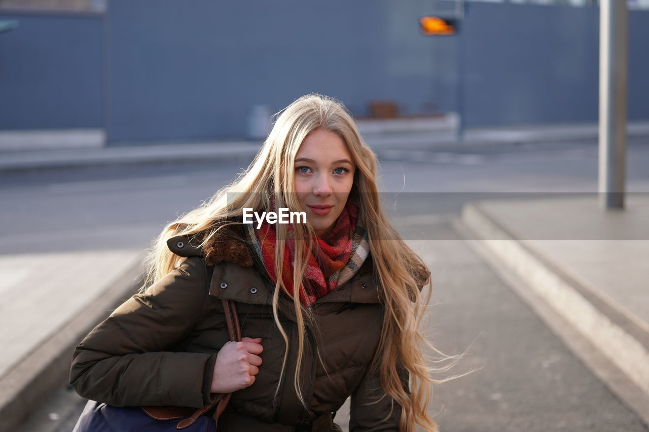 Portrait of girl standing at bus station