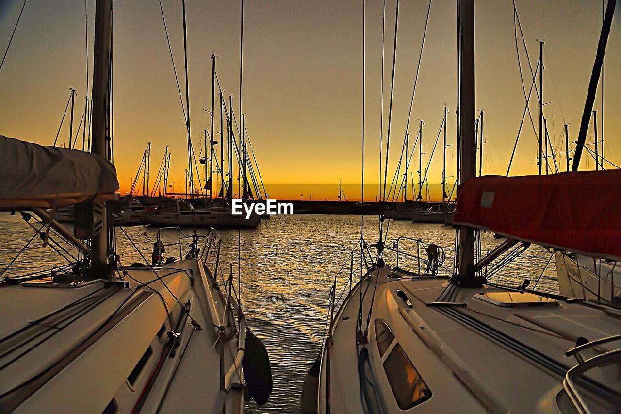 SAILBOAT IN SEA AT SUNSET