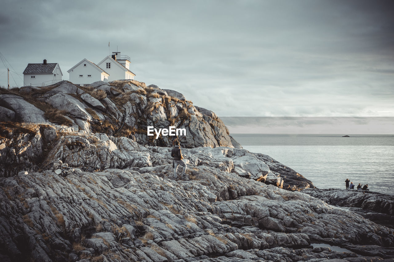 Young people watching the sunset in norwegian fishing village