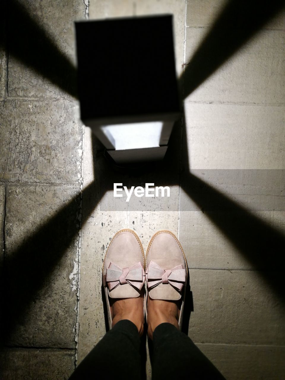 Low section of woman standing on tiled floor