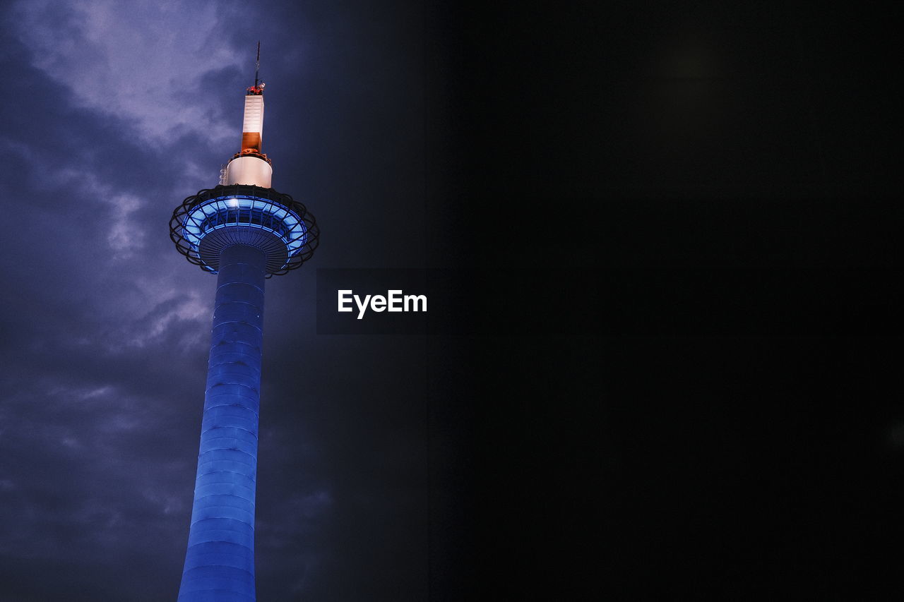 Low angle view of illuminated tower against sky at night