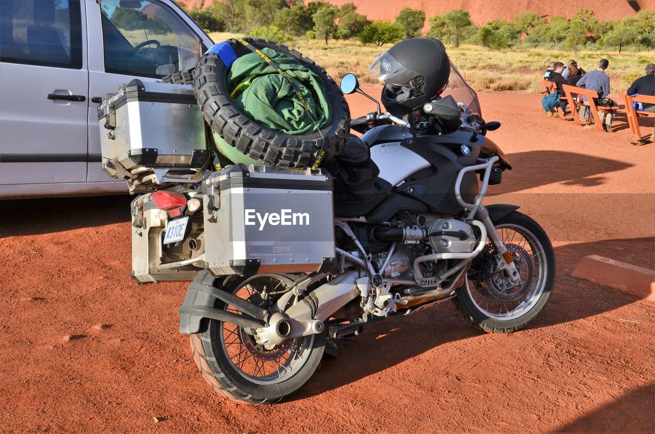 Motor cycle parked near car