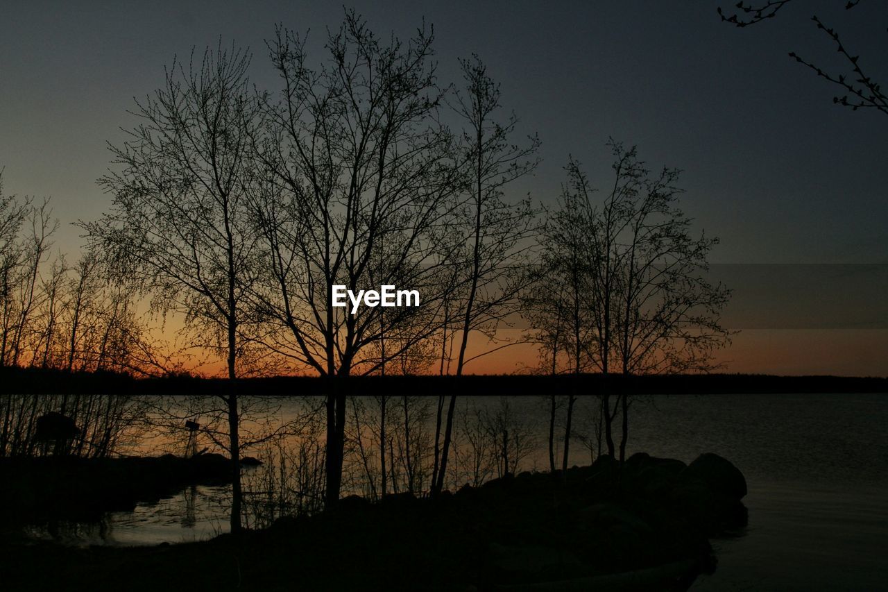 SCENIC VIEW OF LAKE AT SUNSET