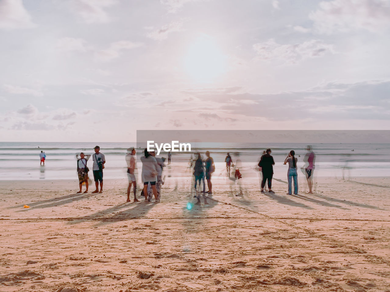 People at beach against sky
