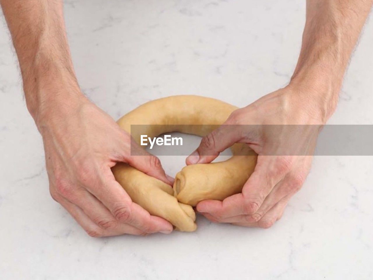 cropped hands of man holding food on table