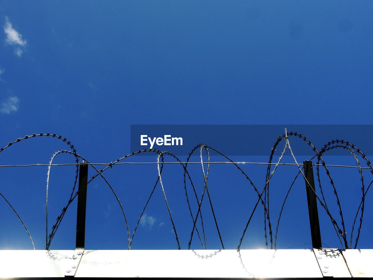 Barbed wire against sky