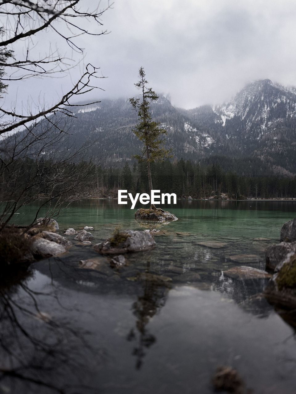 Cloudy day by the turquoise color lake