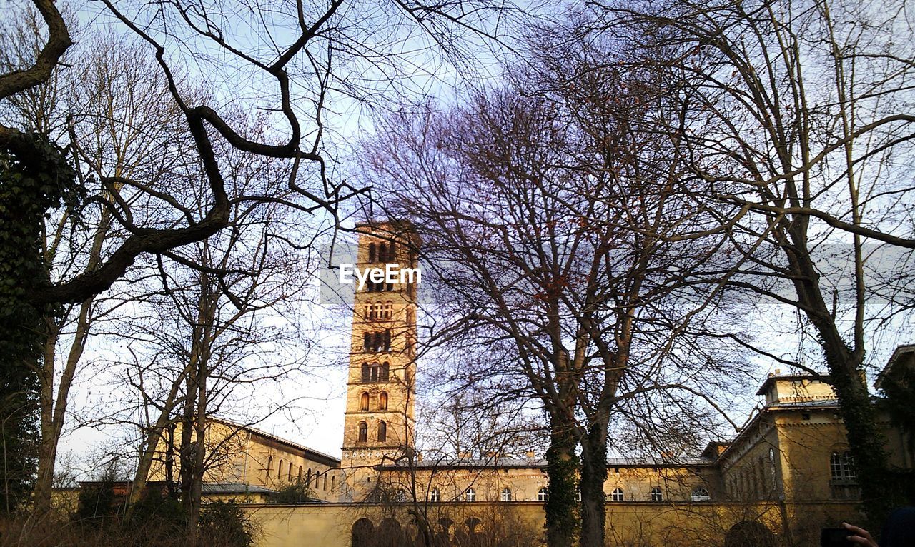 Low angle view of bare trees against church of peace in sanssouci park
