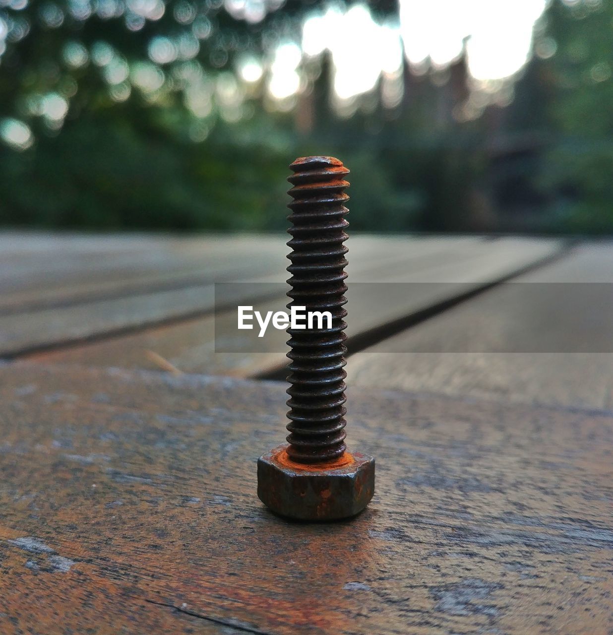 CLOSE-UP OF RUSTY METALLIC CONTAINER ON TABLE