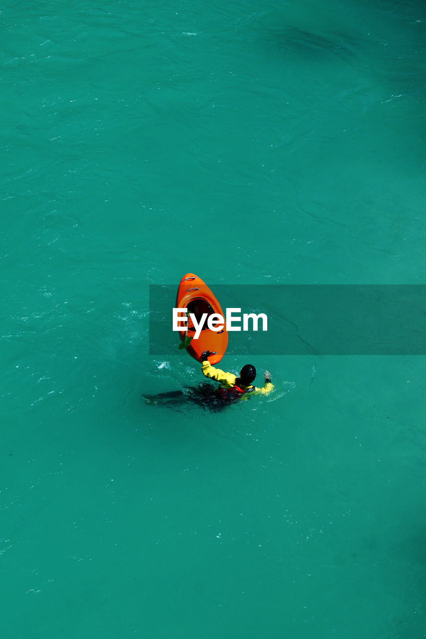 High angle view of empty boat and person floating on river