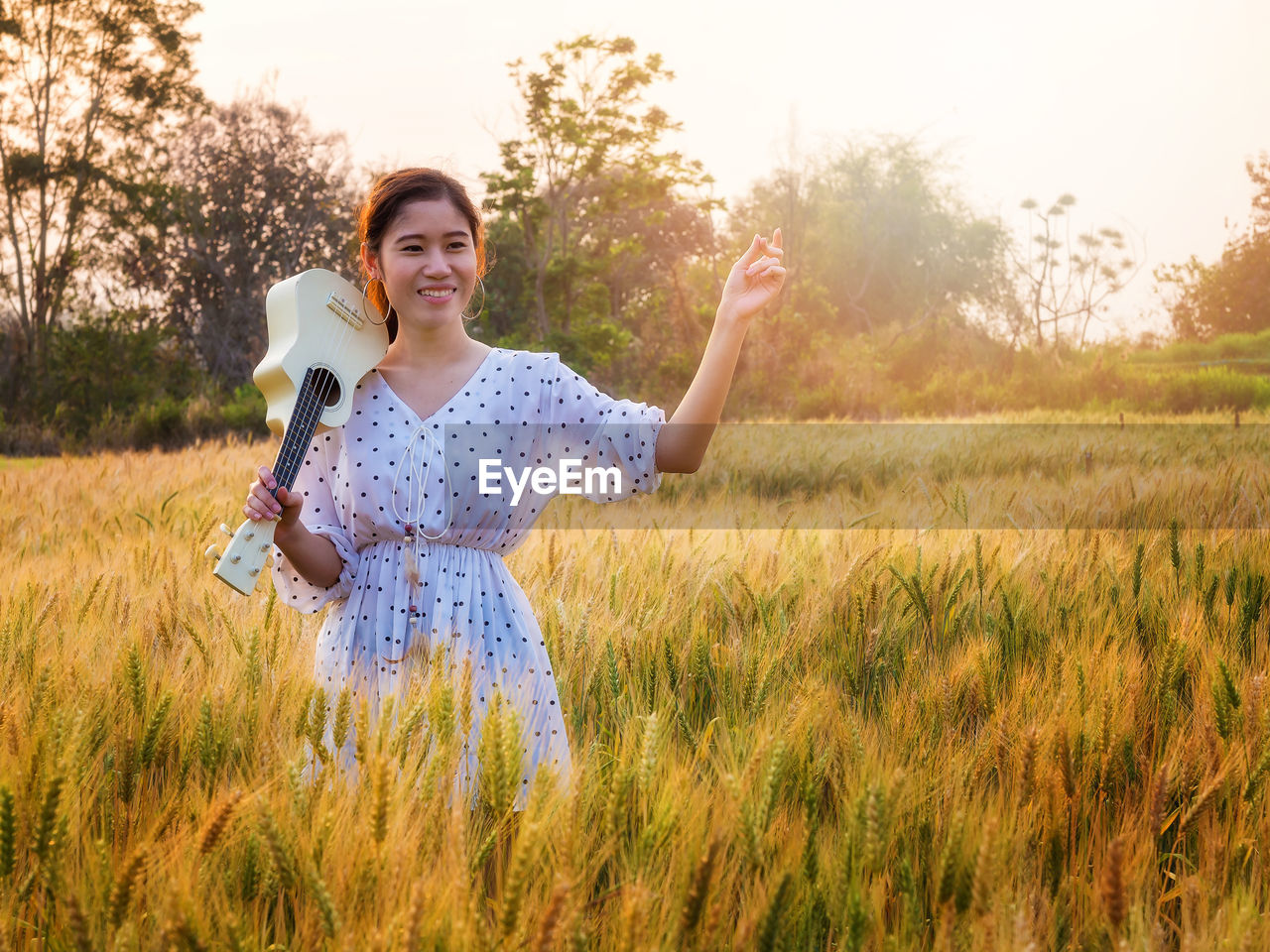 portrait of young woman standing amidst plants