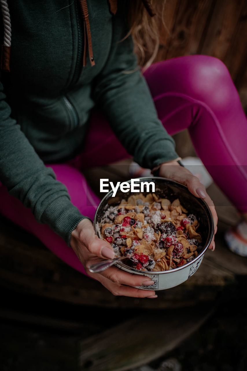 Midsection of woman holding ice cream