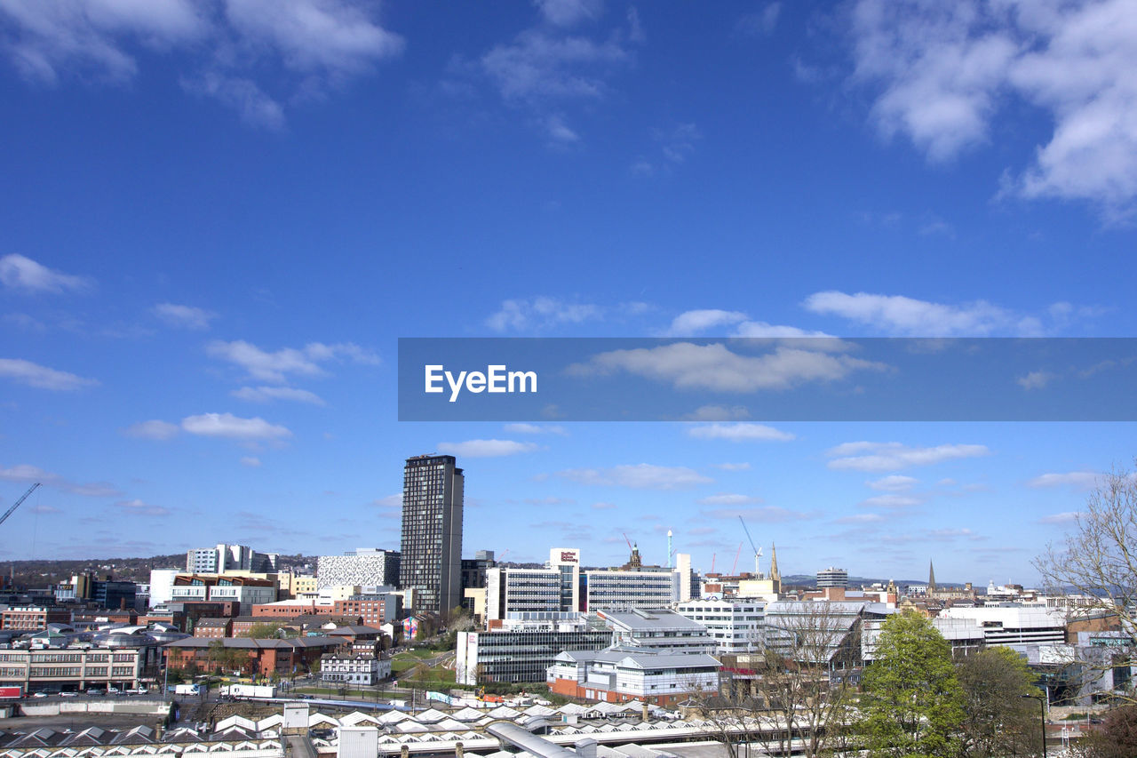 High angle view of sheffield buildings against blue sky