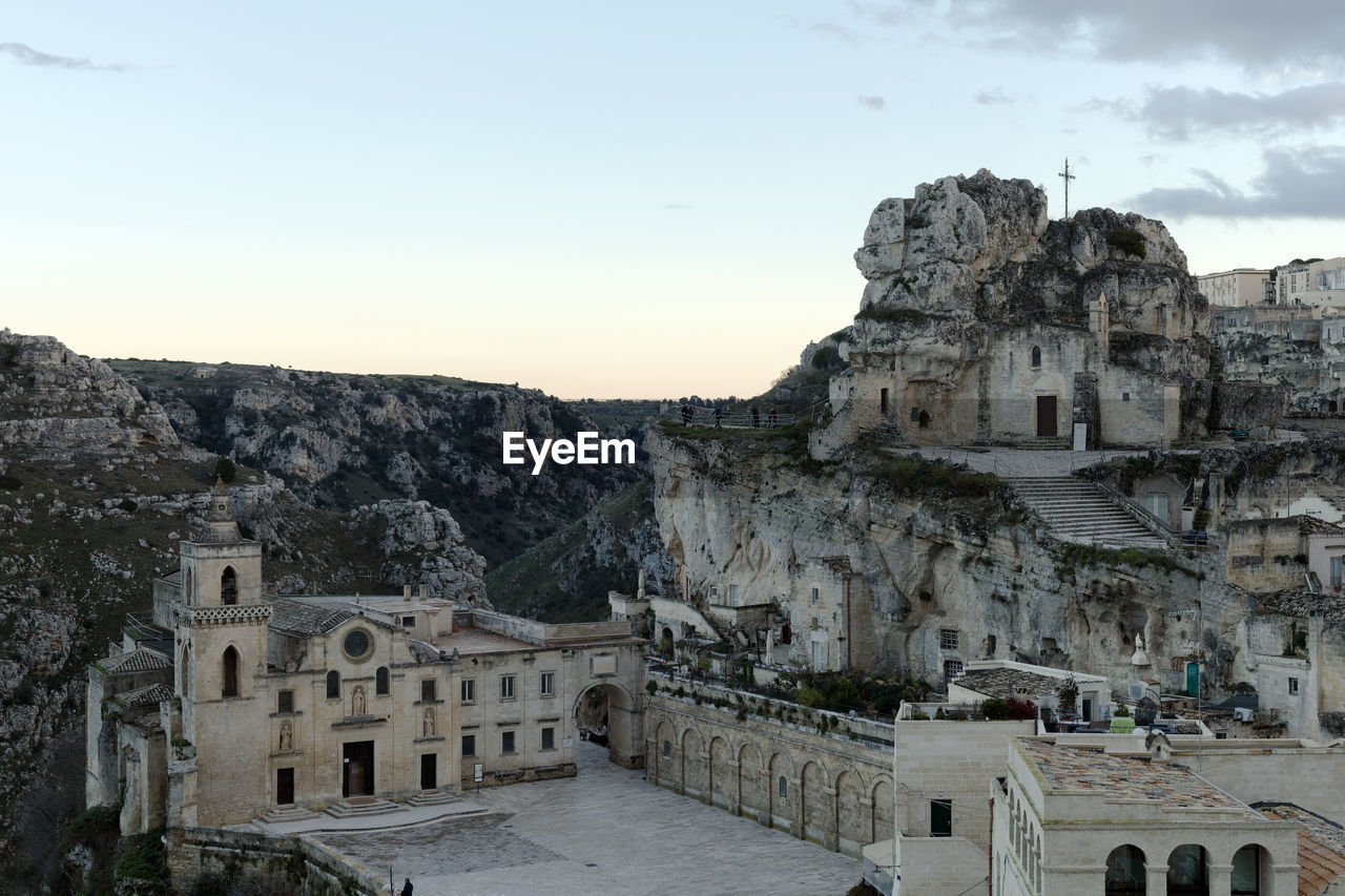 architecture, travel destinations, history, built structure, the past, ancient history, sky, building exterior, travel, ruins, tourism, building, nature, ancient, religion, historic site, landmark, town, belief, place of worship, city, stone material, outdoors, old ruin, spirituality, old, temple - building, mountain, rock, castle, temple, land, fortification, environment, memorial, no people