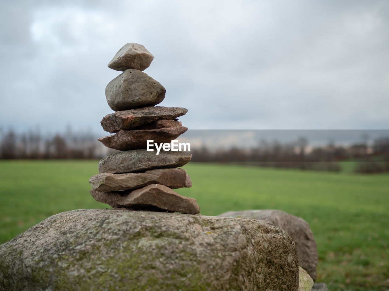 STACK OF STONES ON FIELD