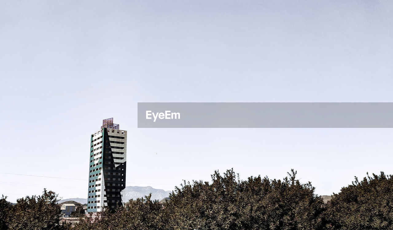 LOW ANGLE VIEW OF BUILDINGS AGAINST CLEAR SKY