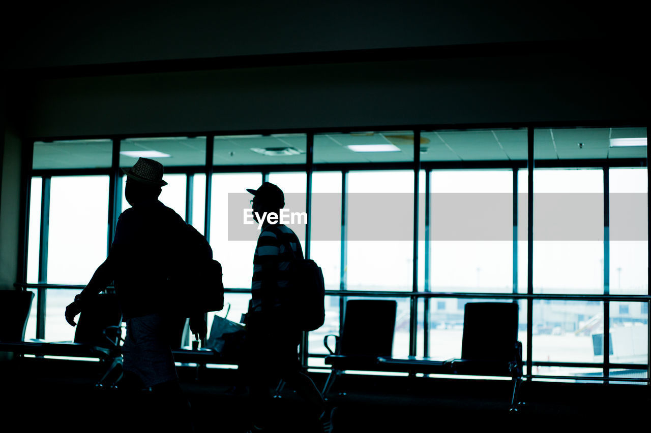 SILHOUETTE PEOPLE WALKING ON AIRPORT