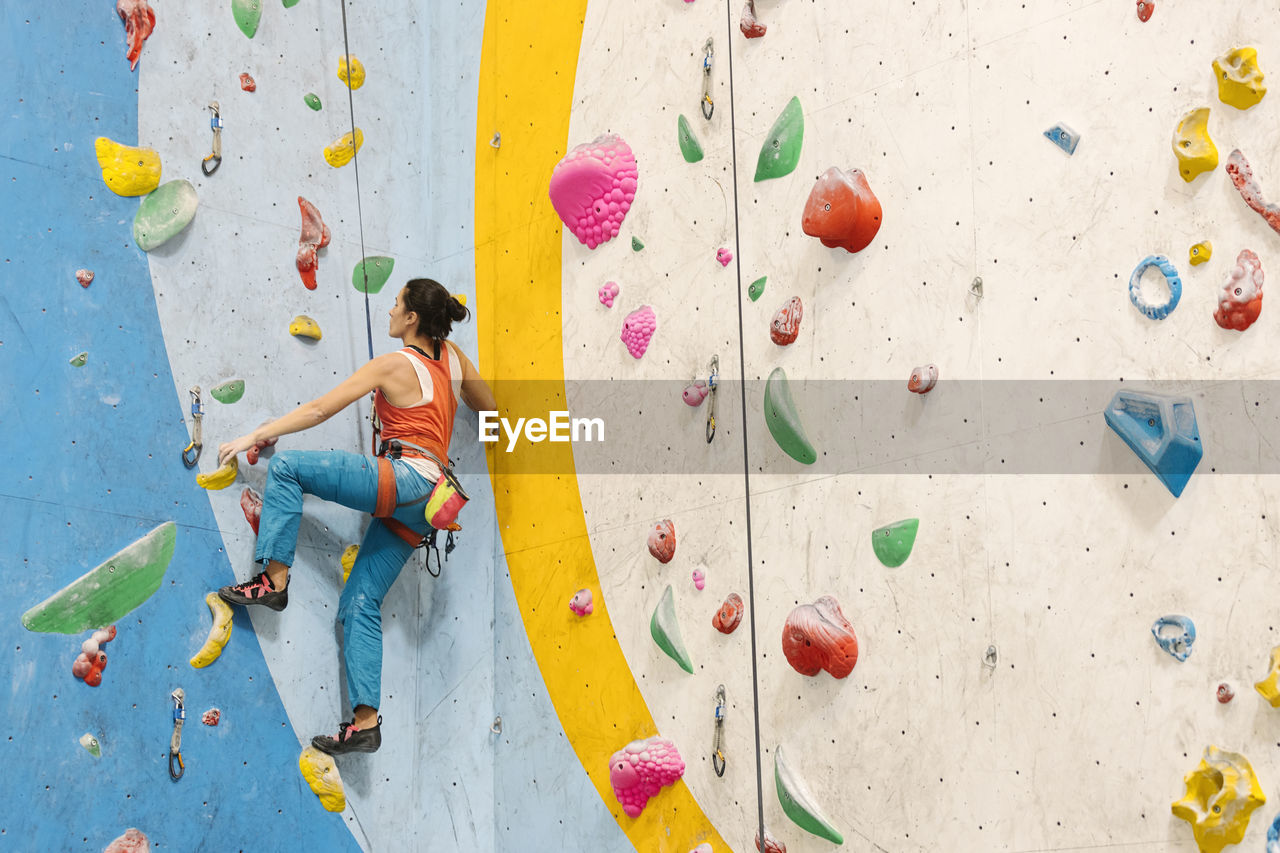 Woman climbing on wall