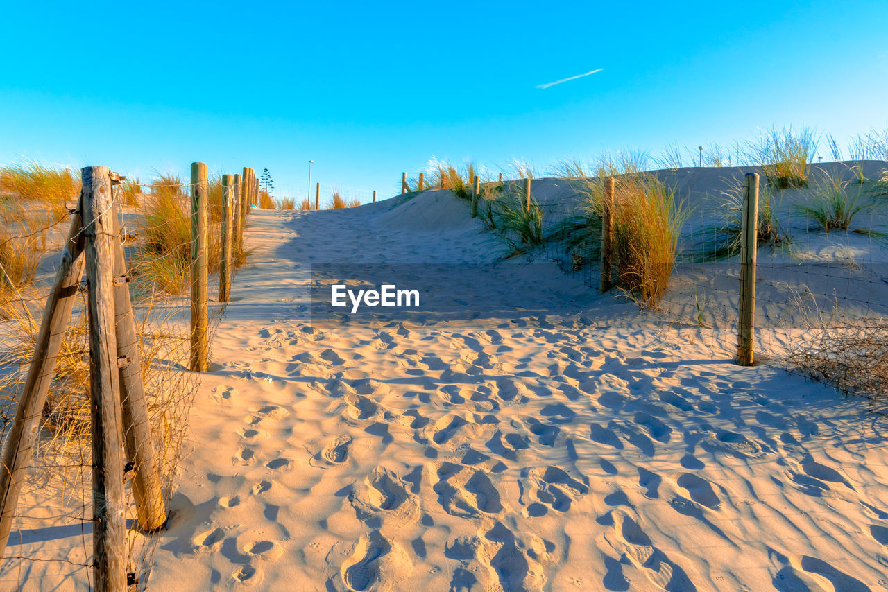 Scenic view of beach against sky during winter