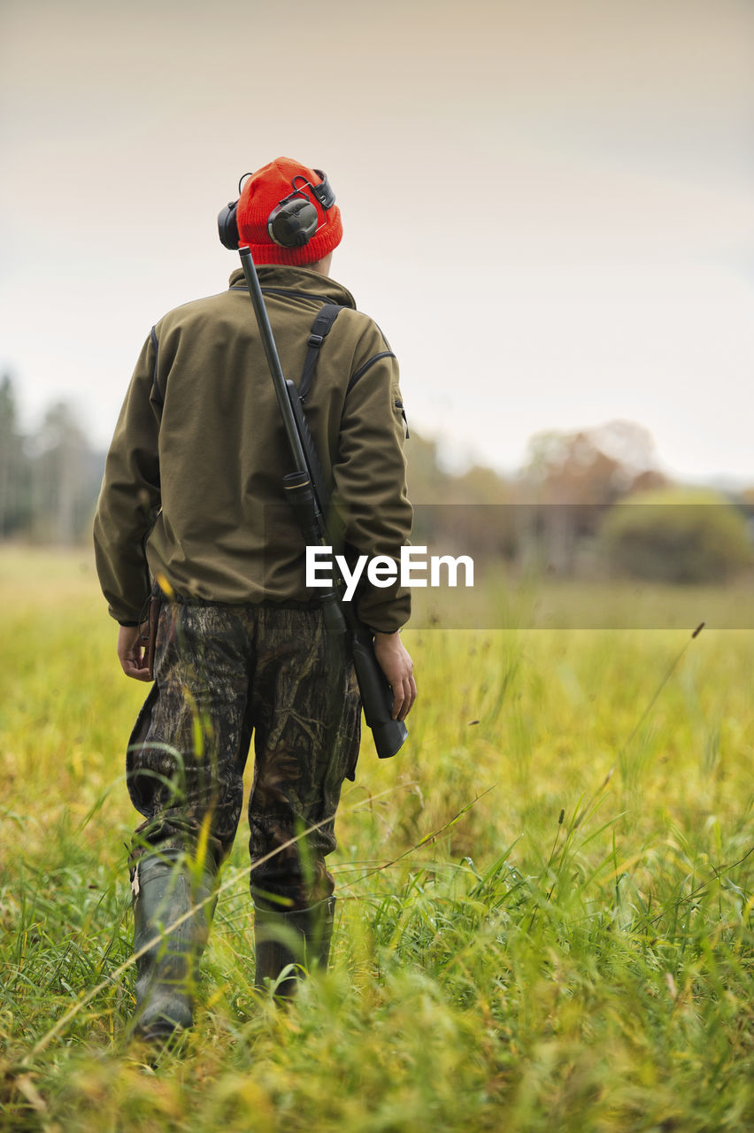 Teenage boy with rifle at hunting