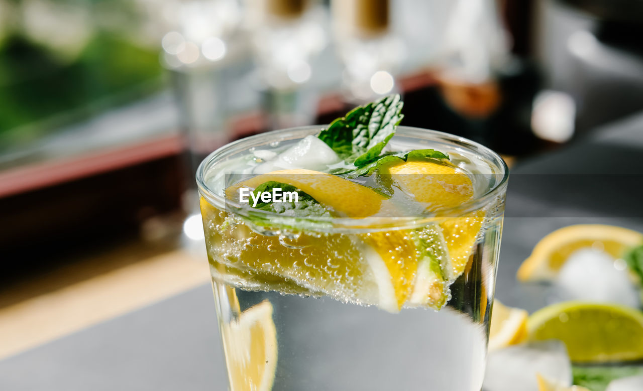 Refreshing iced infused water with lime, lemon and mint. summer drink, cocktail concept.