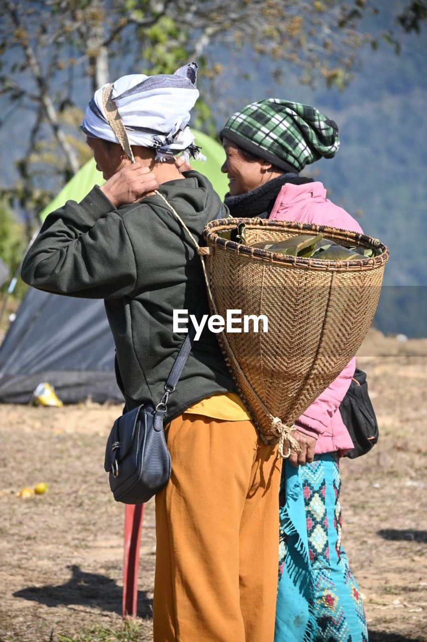 clothing, spring, adult, men, two people, nature, women, day, outdoors, person, carrying, hat, rear view, standing, child, basket, childhood, female, holding, traditional clothing, togetherness, focus on foreground, land, lifestyles