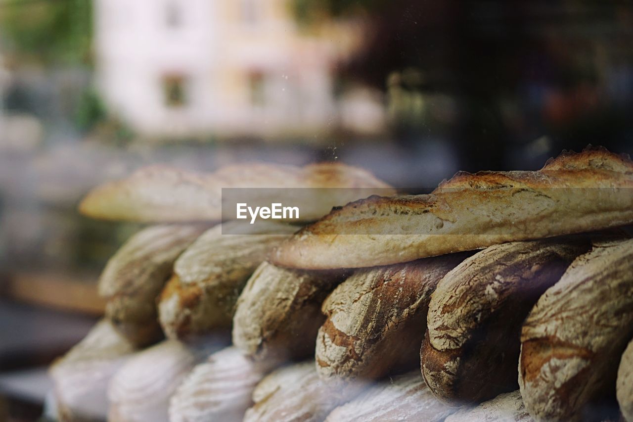 Baked breads at store seen through glass