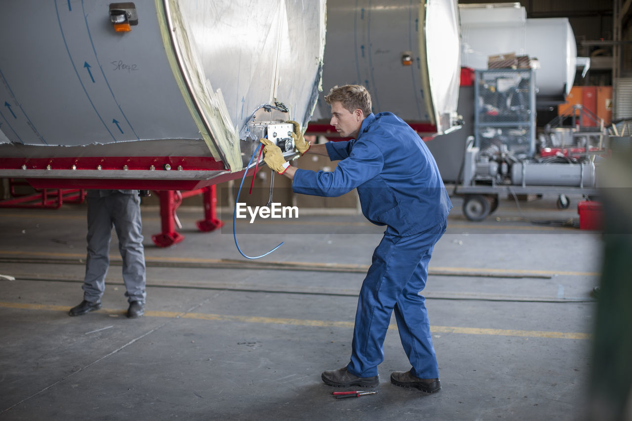 Industrial worker checking containers settings