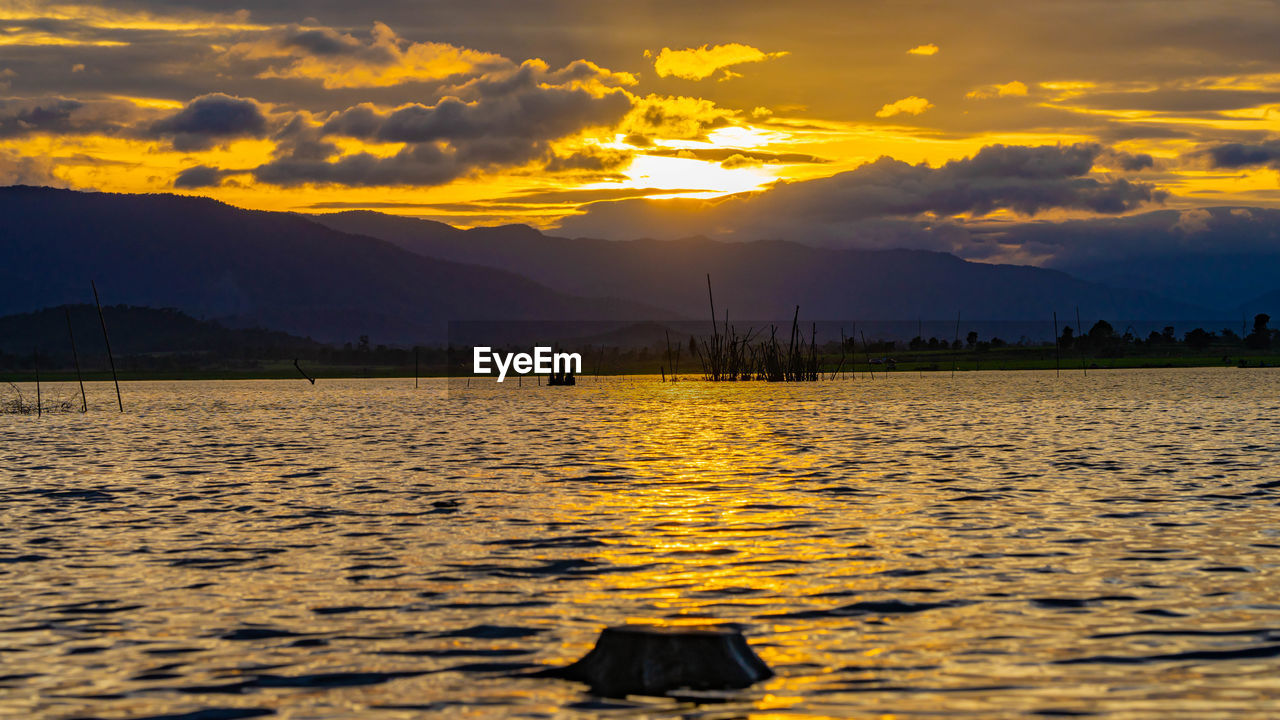 Scenic view of lake against sky during sunset