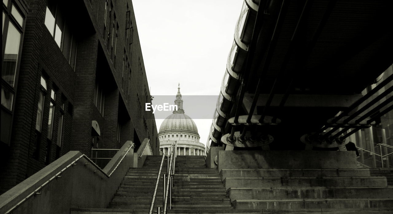 LOW ANGLE VIEW OF STAIRCASE IN CITY AGAINST CLEAR SKY